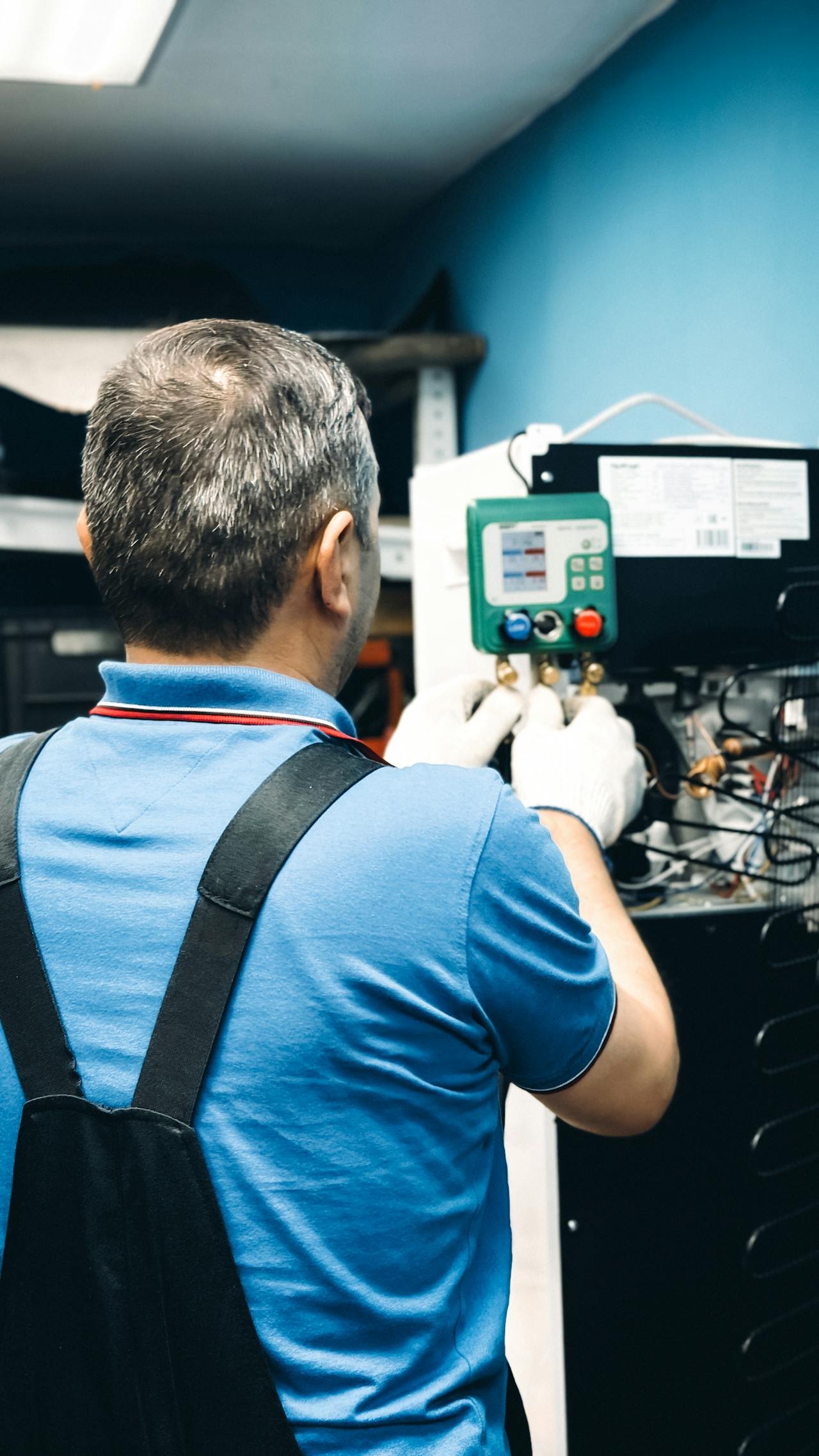 HVAC technician working on air conditioning control panel